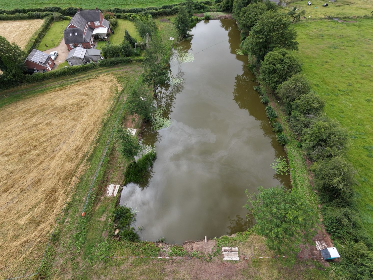 Aerial view of Hammersley Pools, the fishing pool from above set among the fields at White Farm